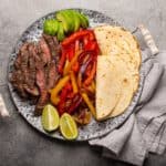 Mexican dish Beef fajitas with tortillas from above