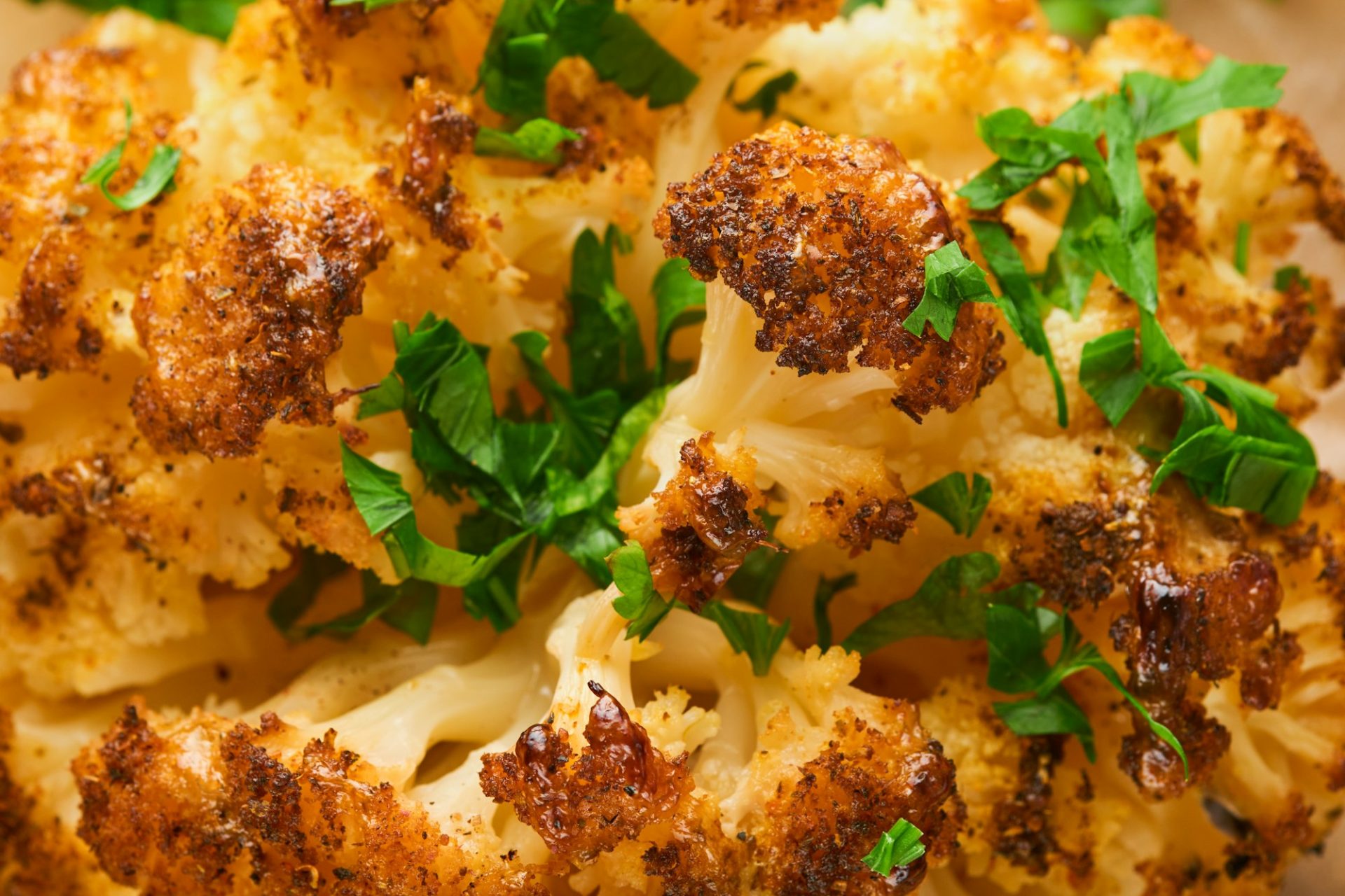 Baked cauliflower abstract food background. Oven or whole baked cauliflower spices and herbs server